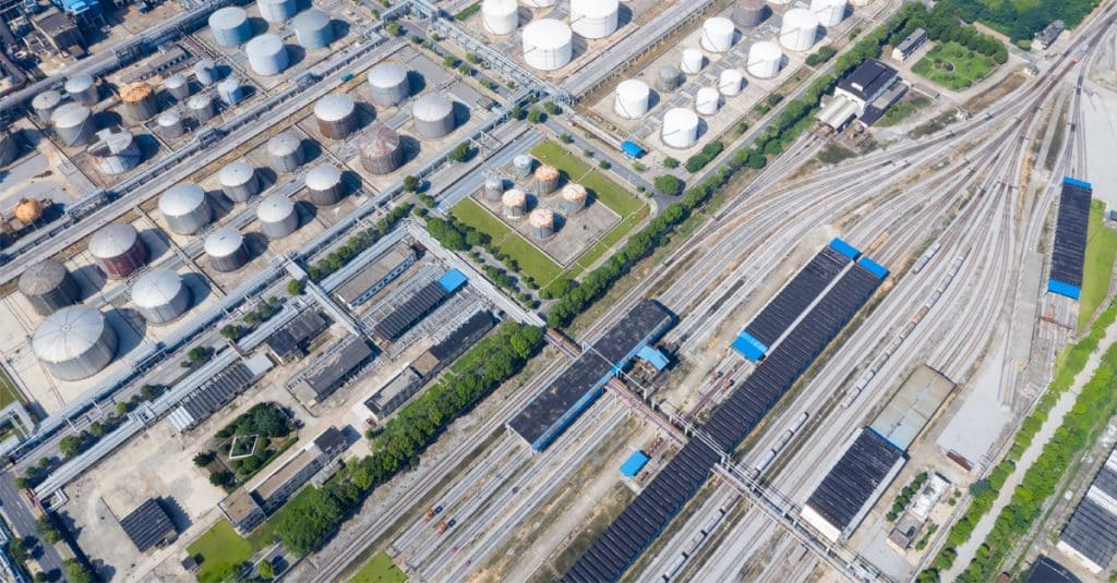 A top down view of a railway marshalling station and petrochemical plant.