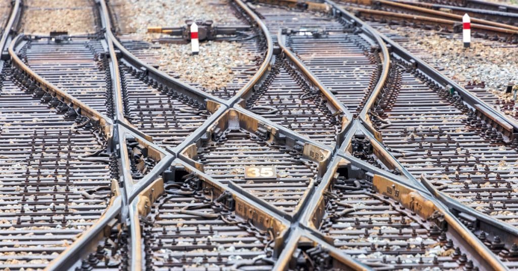 Several rail tracks split and merge in a rail interchange.