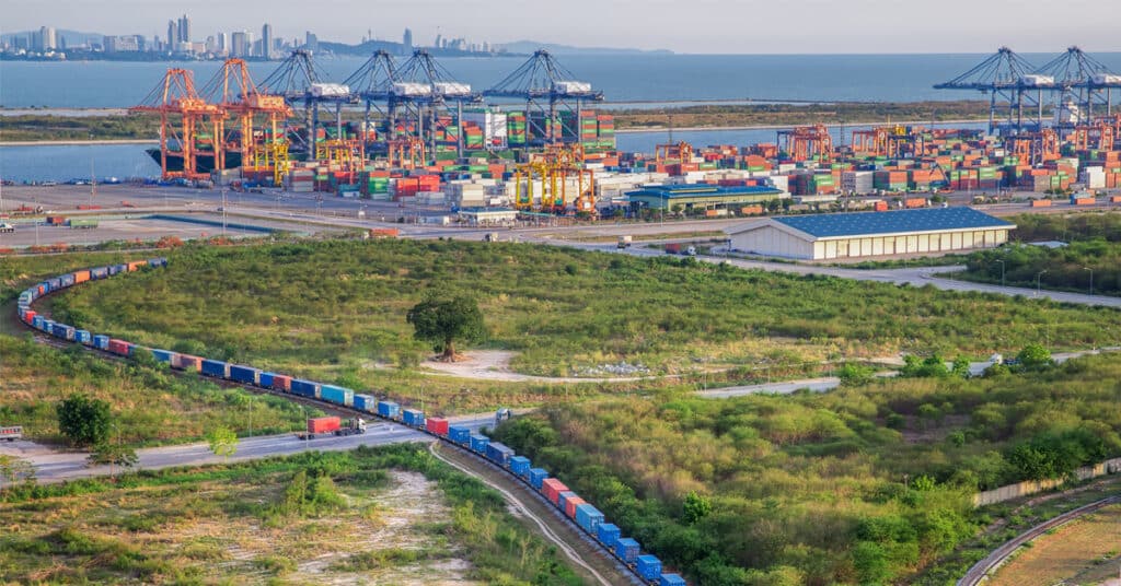 The transportation of intermodal freight shown in three modes at the same time; rail, truck, and ship.