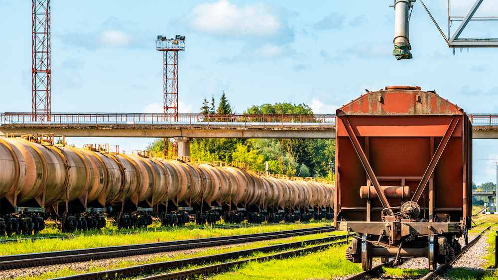 Railcar standing near a grain elevator in an agriculture zone.