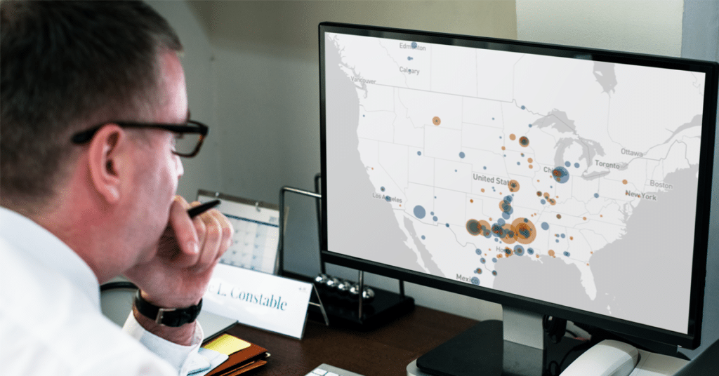 A man in a white shirt looks at the Rail Command sighting graph on a computer screen.
