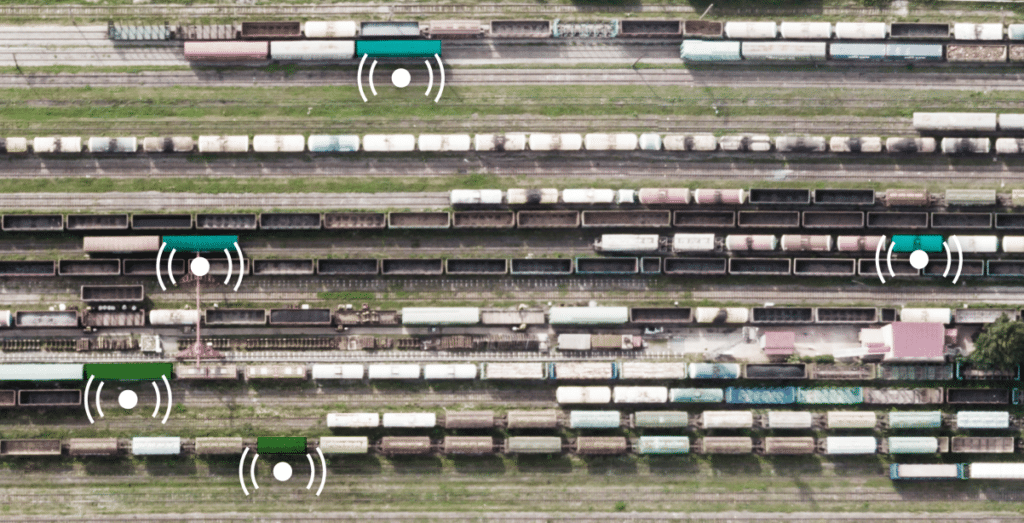 A rail yard with yard management indicators overtop the lines of rail cars.